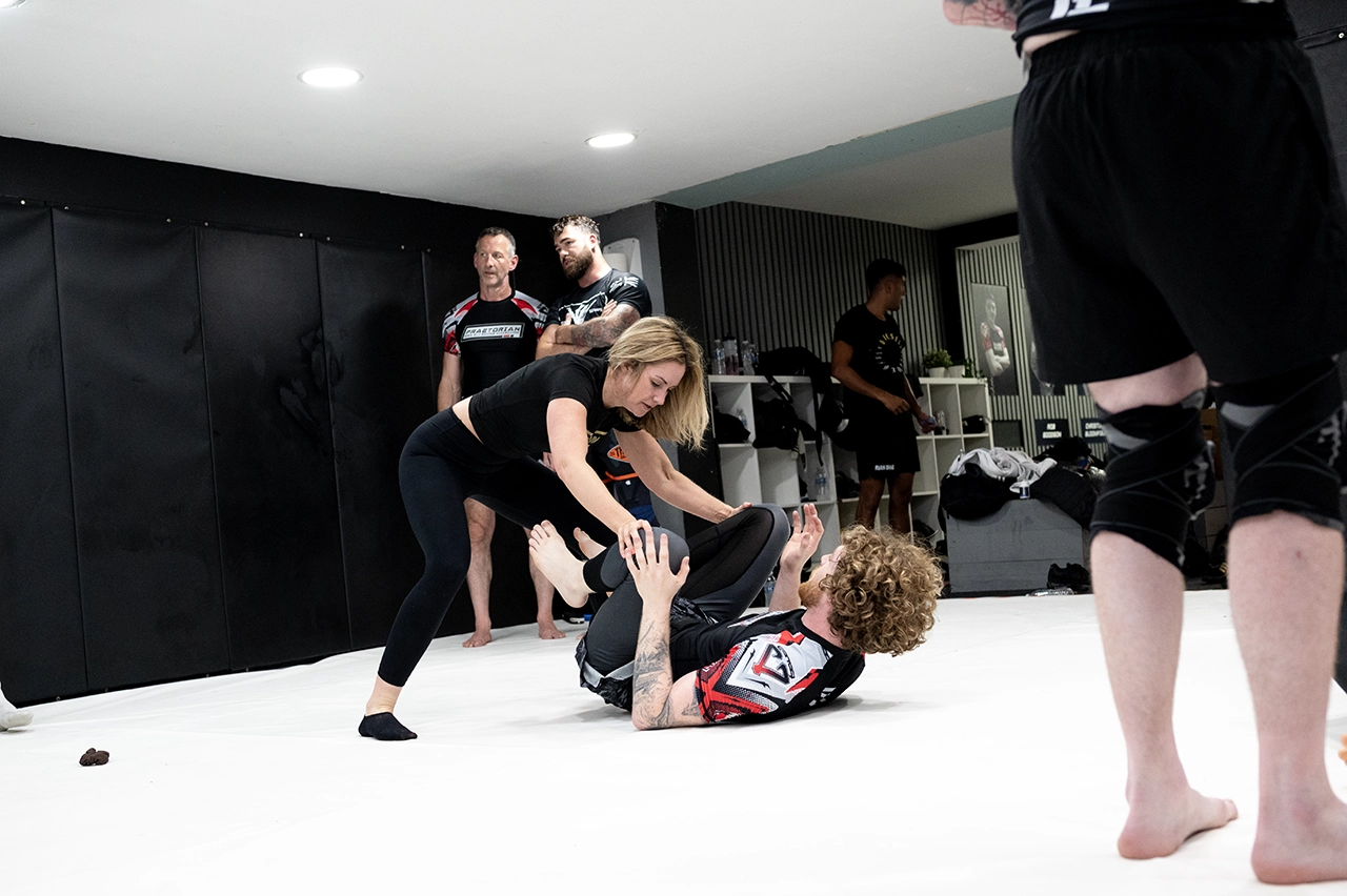 Kelly Sparks attempting a guard pass during Brazilian Jiu Jitsu training at Praetorian MMA