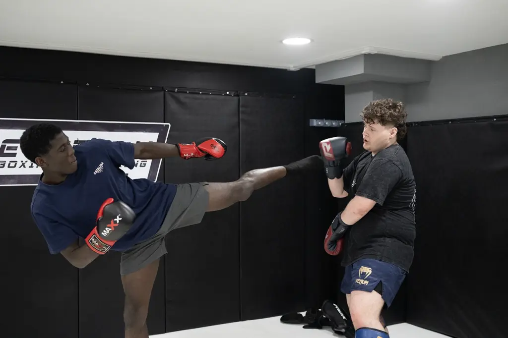 Two Praetorian MMA members working together during a kickboxing class