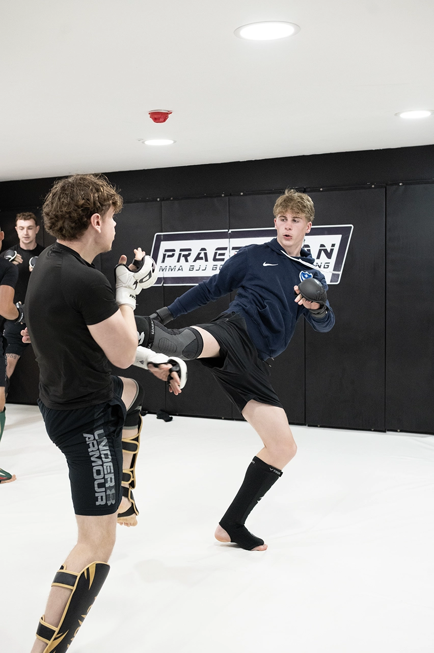 Teenagers training MMA striking at Praetorian MMA, practising punches and movement during a structured teen combat sports class