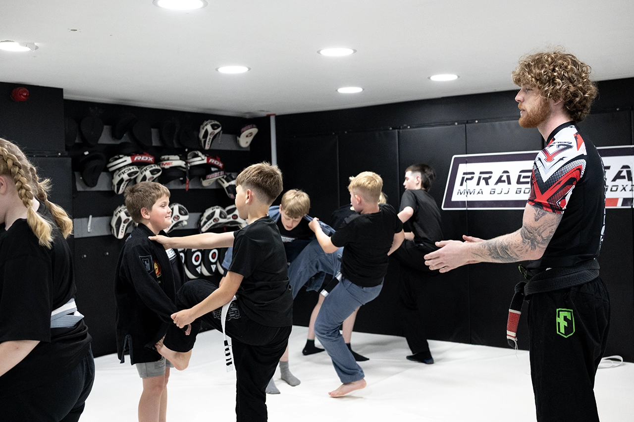 Nathan Johnstone teaching Brazilian Jiu Jitsu to young students during a Gi class at Praetorian MMA