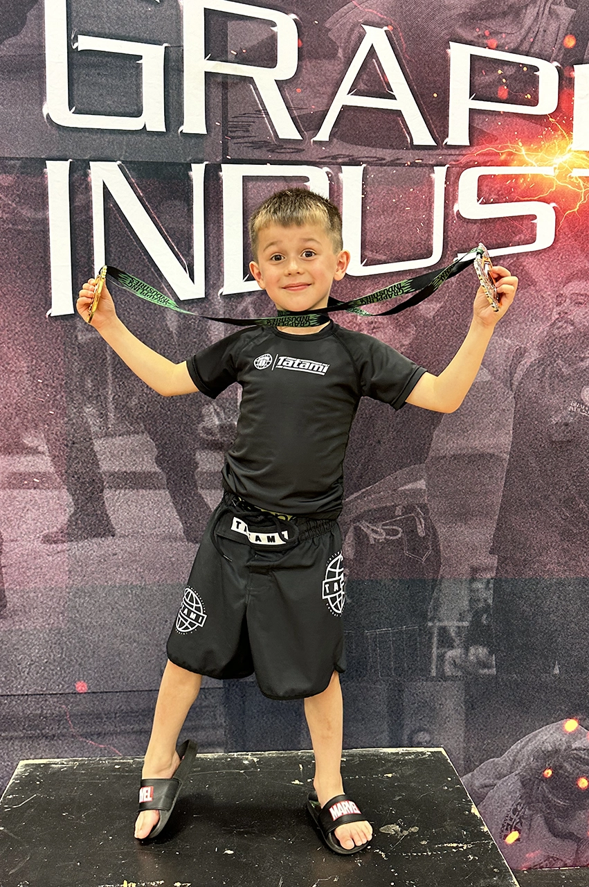 Praetorian MMA junior student celebrating a BJJ competition win